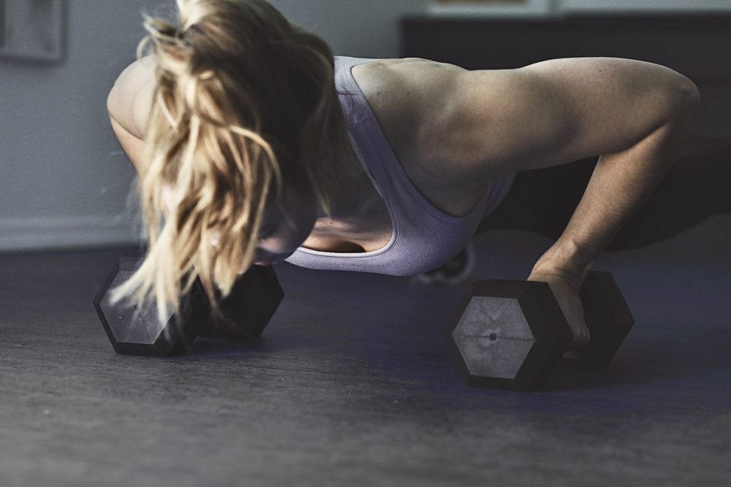 Female personal trainer performing a push up