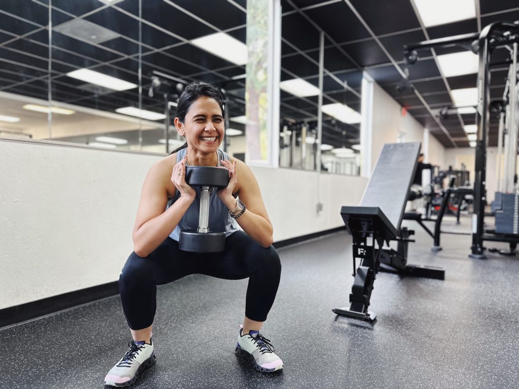 Female client demonstrating a goblet squat