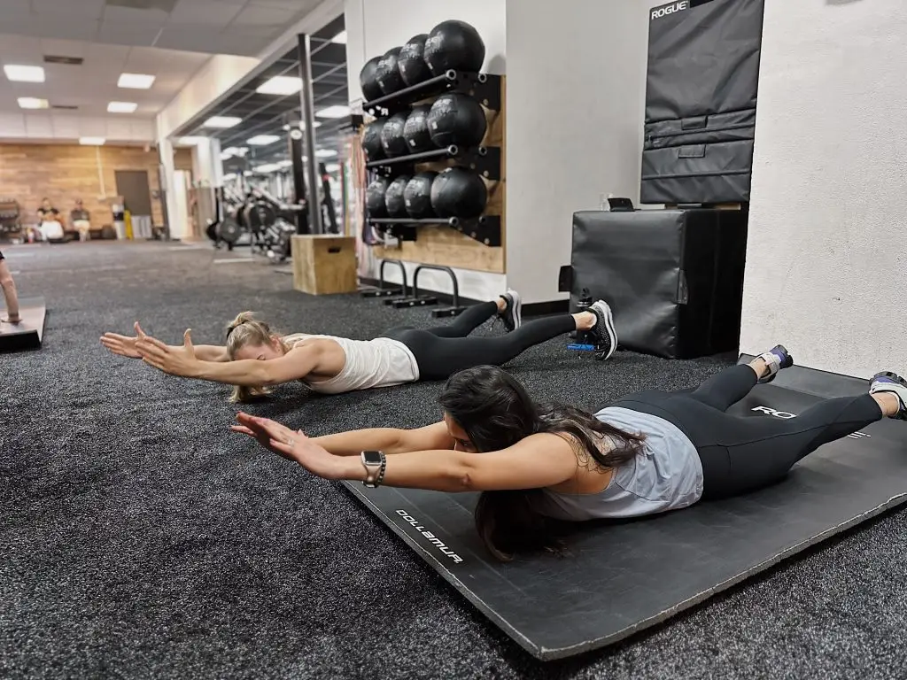 Coach and client performing a shoulder warm up
